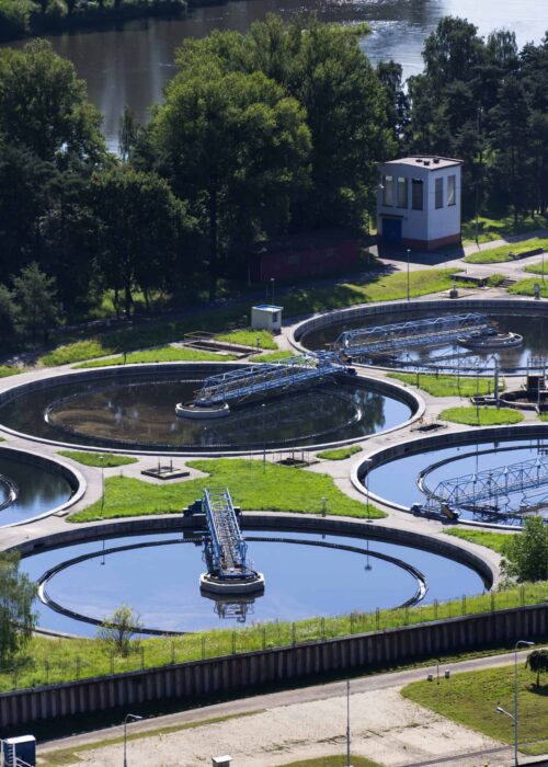 Sewage water treatment plant with river in background aerial view